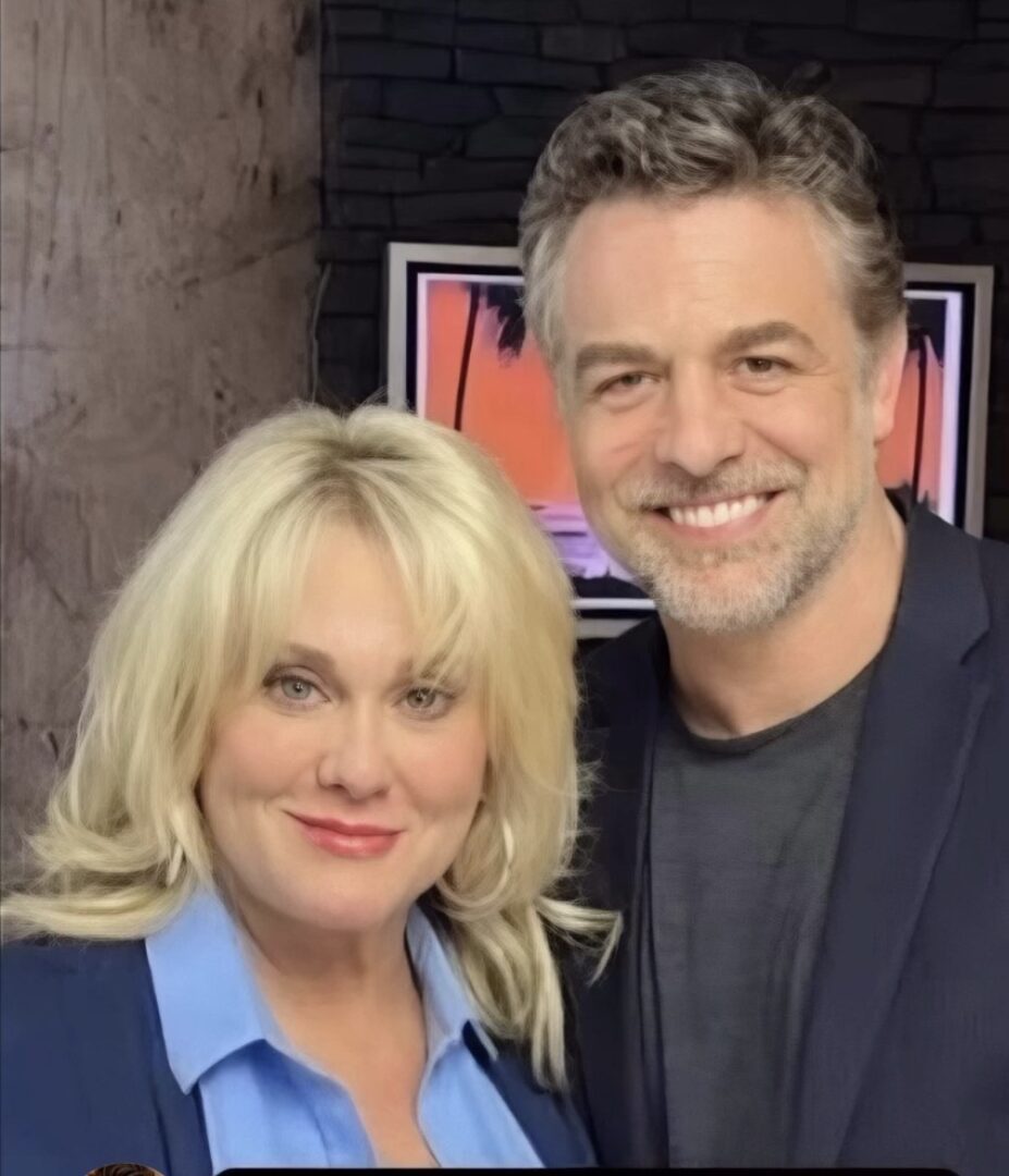 Smiling blonde woman and man in studio